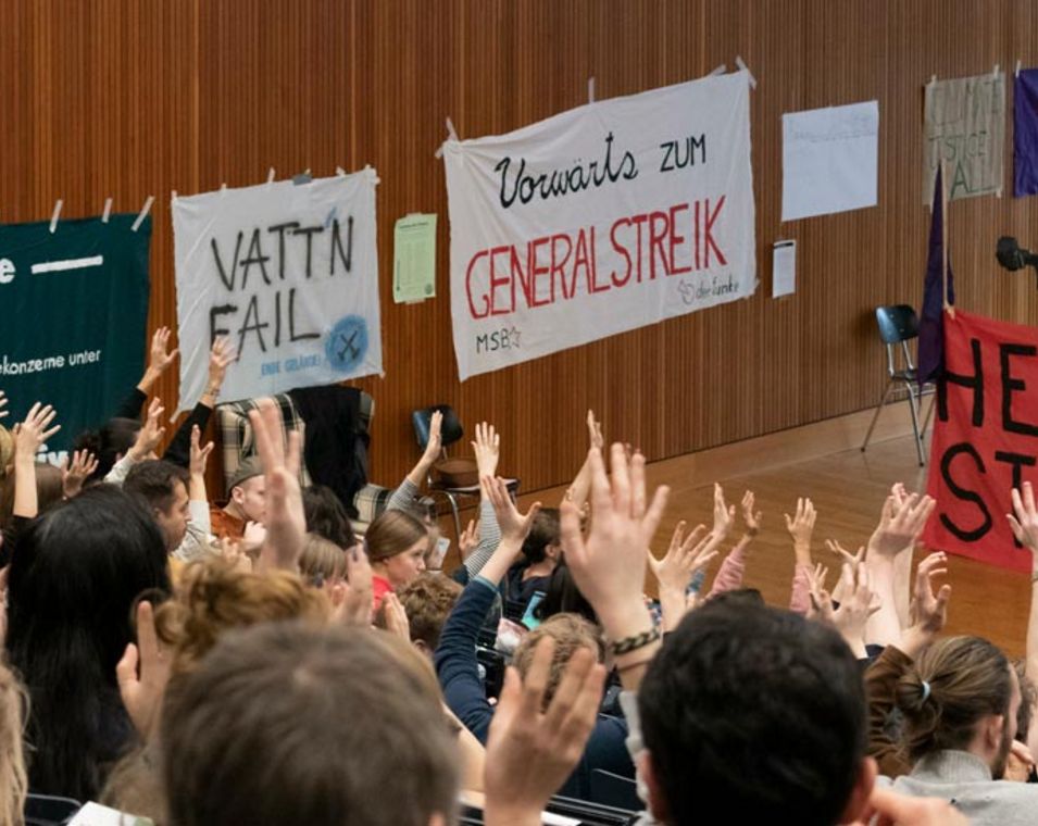 Studierende in einem Hörsall mit vielen Plakaten von Fridays for Future und "Heute Streik". 