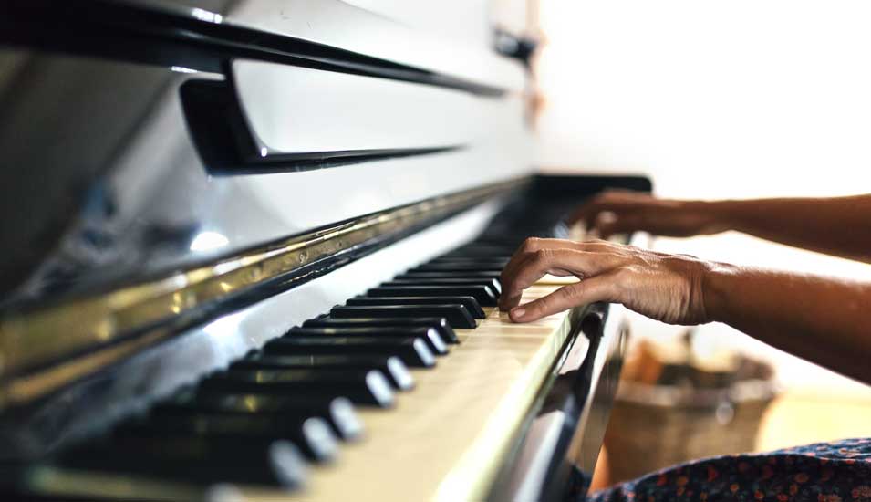 Das Foto zeigt eine Klaviertastatur mit den Händen eines Pianisten