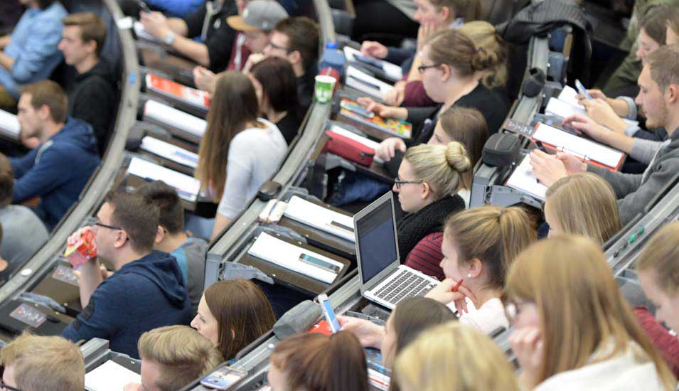 Das Bild zeigt Studierende in einem vollen Hörsaal