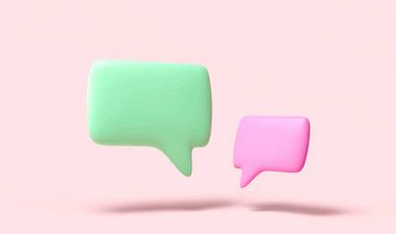 Symbolbild Dialog: Grüne und pinke Sprechblase vor rosa Hintergrund