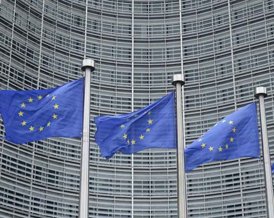 Das Bild zeigt europäische Flaggen vor dem Gebäude der Europäischen Kommission in Brüssel