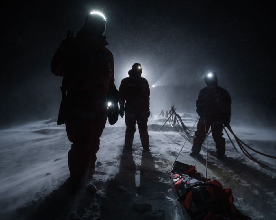 Wissenschaftler auf dem Eis während der Polarnacht: Sie sind nur als dunkle Gestalten im Schein ihrer Stirnlampen zu erkennen.