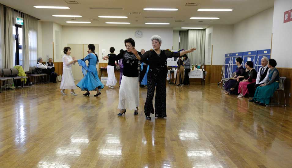 Das Foto zeigt alte Menschen in Japan beim Tanz.