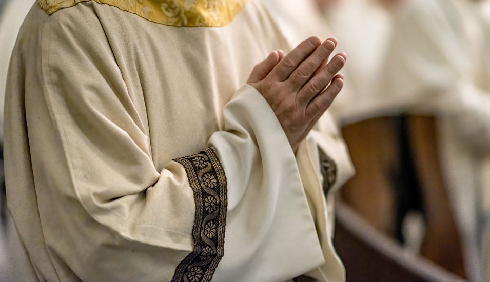Betende Hände eines katholischen Priesters