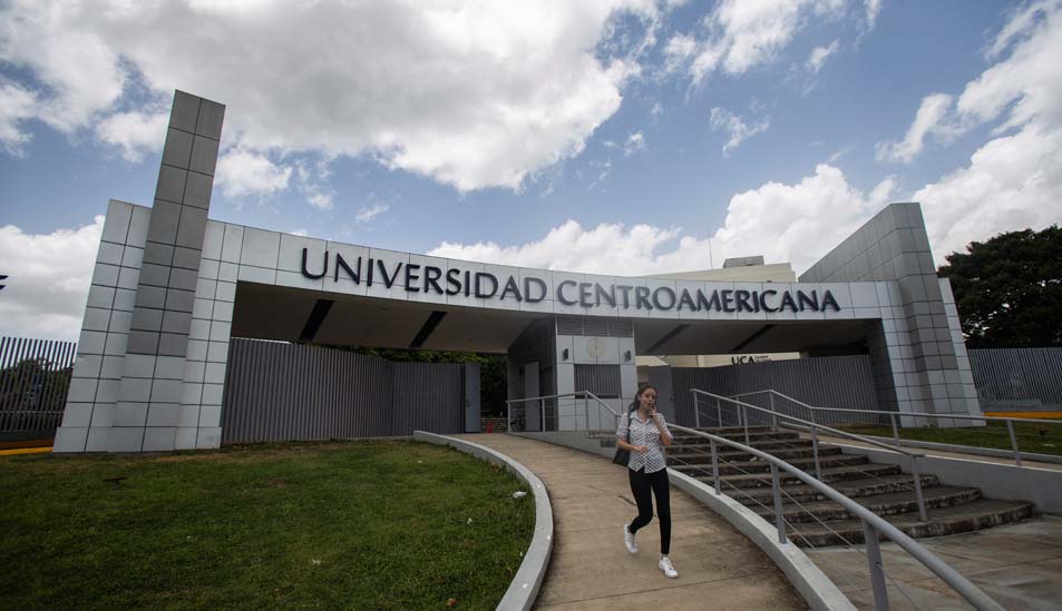 Eine Frau verlässt ein Gebäude der Universidad Centroamericana