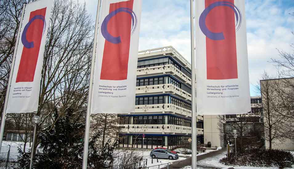 Das Foto zeigt mehrere Fahnen vor dem Gebäude der Hochschule Ludwigsburg.