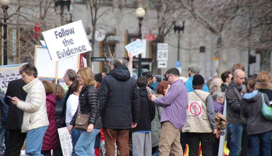 Eine Gruppe Demonstrierender mit Plakaten "Save the evidence"