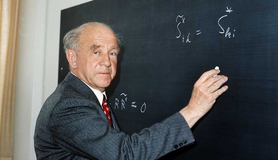 Das Foto zeigt den Physiker Werner Heisenberg an einer Tafel.