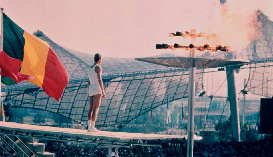 Der westdeutsche Mittelstreckenläufer Gunter Zarn steht bei der Eröffnungsfeier im Olympiastadion in München in der Nähe des olympischen Feuers am 26. August 1972.